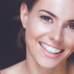 Close up of a pretty browned eyed smiling brunette woman