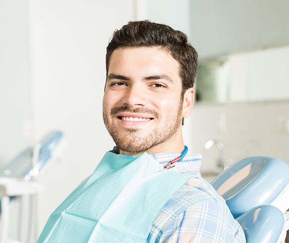 man sitting in a dental chair