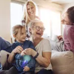 Grandma enjoying with family visiting. Senior dental care is important to maintain oral health as we age.