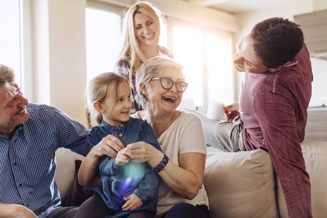 Grandma enjoying with family visiting. Senior dental care is important to maintain oral health as we age.