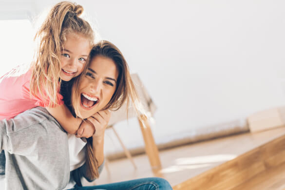 a girl and her mom smiling