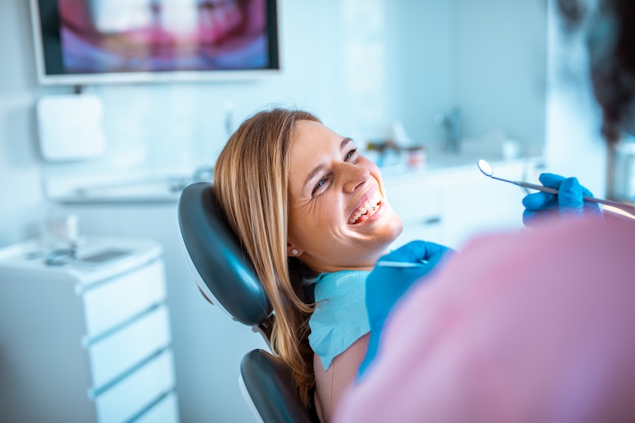 how often should you visit the dentist, woman in dental chair