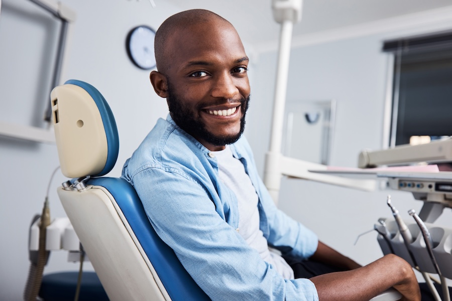 man ind ental chair for cosmetic dental options like veneers, bonding, or crowns