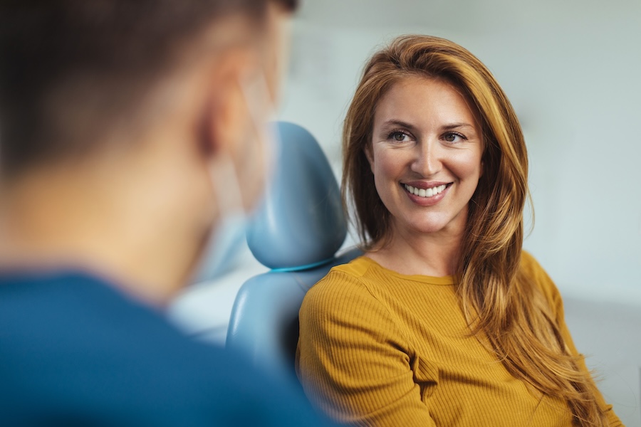 woman discussing dental extraction or root canal or wisdom teeth removal with her dentist