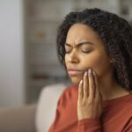 Black woman with toothache for dental emergency