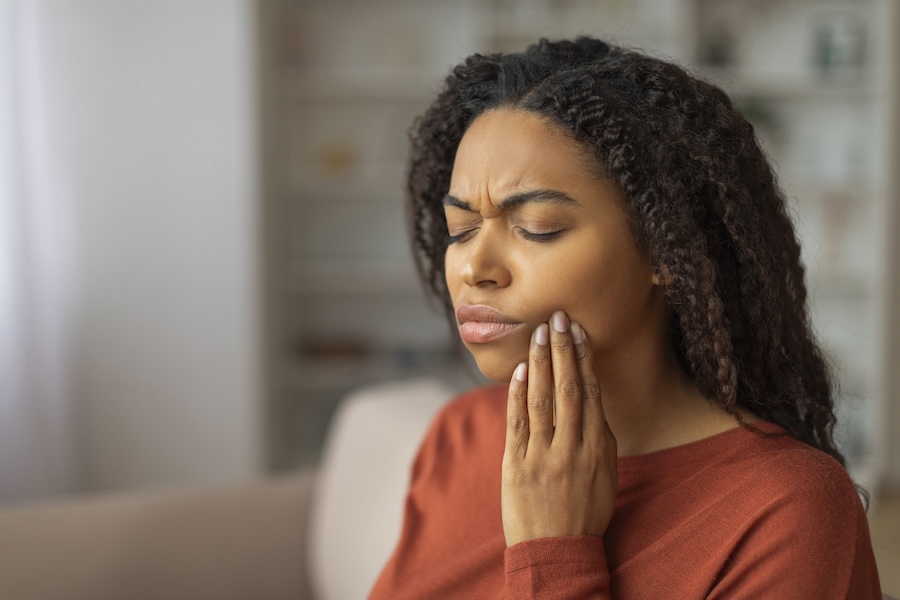 Black woman with toothache for dental emergency