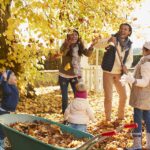 family playing in fall leaves, need to use dental benefits in the fall